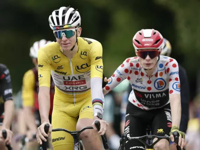 Cycling - Tour de France - Stage 20 - Nantua to Pontarlier - Pontarlier, France - July 26, 2025 UAE Team Emirates XRG's Tadej Pogacar and Team Visma | Lease a Bike's Jonas Vingegaard cross the finish line after stage 20 REUTERS/Benoit Tessier