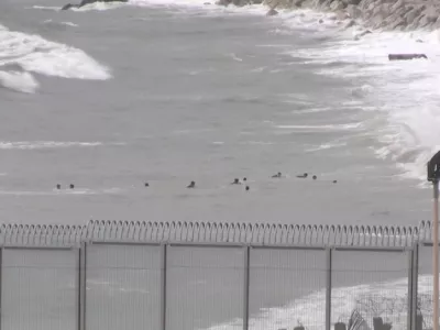 A view shows migrants swimming towards the shore on Moroccan side of border, as at least 54 children and about 30 adults swam from Morocco to Spain's North African enclave of Ceuta, in Ceuta, Spain July 26, 2025, in this screengrab obtained from a video. FARO TV/Handout via REUTERS  THIS IMAGE HAS BEEN SUPPLIED BY A THIRD PARTY. SPAIN OUT. NO COMMERCIAL OR EDITORIAL SALES IN SPAIN