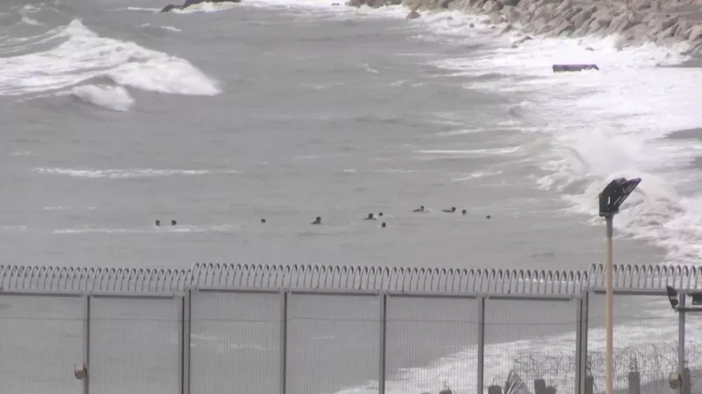 A view shows migrants swimming towards the shore on Moroccan side of border, as at least 54 children and about 30 adults swam from Morocco to Spain's North African enclave of Ceuta, in Ceuta, Spain July 26, 2025, in this screengrab obtained from a video. FARO TV/Handout via REUTERS  THIS IMAGE HAS BEEN SUPPLIED BY A THIRD PARTY. SPAIN OUT. NO COMMERCIAL OR EDITORIAL SALES IN SPAIN
