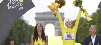 Slovenia's Tadej Pogacar, the Tour de France winner, celebrates during the presentation ceremony for the Tour de France on the Champs-Elysees in Paris, France, Sunday, July 27, 2025. (Bernard Papon, Pool Photo via AP)