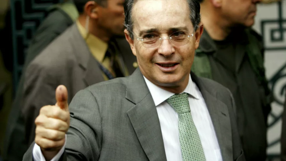Colombian President Alvaro Uribe gestures after casting his vote during his country's presidential elections in Bogota May 28, 2006. Incumbent Uribe is favored to win in Sunday's Colombian presidential election because his security policies have cut crime and kidnapping associated with the country's 40-year insurgency. REUTERS/Jose Miguel Gomez