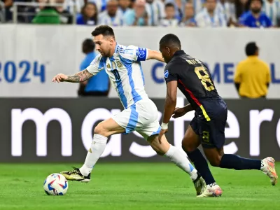 Jul 4, 2024; Houston, TX, USA; Argentina's striker Lionel Messi (10) controls the ball as Ecuador's midfielder Carlos Gruezo (8) defends during the first half at NRG Stadium. Mandatory Credit: Maria Lysaker-USA TODAY Sports