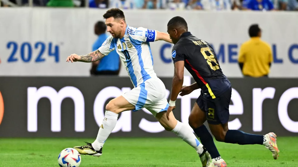 Jul 4, 2024; Houston, TX, USA; Argentina's striker Lionel Messi (10) controls the ball as Ecuador's midfielder Carlos Gruezo (8) defends during the first half at NRG Stadium. Mandatory Credit: Maria Lysaker-USA TODAY Sports