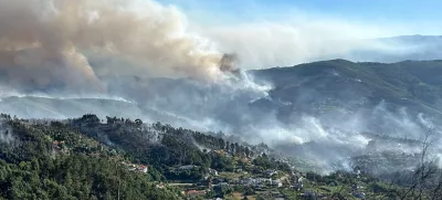 Smoke from a wildfire rises over the hills near the village of Canelas, Arouca region, Portugal, July 29, 2025. REUTERS/Miguel Pereira