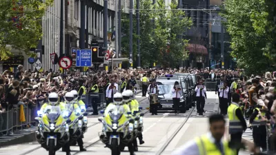 The funeral cortege of Black Sabbath frontman Ozzy Osbourne travels along Broad Street during his funeral procession, in Birmingham, England, Wednesday July 30, 2025. (Jacob King/PA via AP)