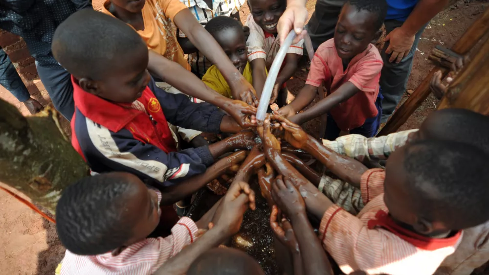 Maga Maga, city in Mayuge District, Uganda, Africa - August 1, 2017: Children at an orphanage in Uganda are happy with a new solar water pump that brings needed water to their living area. A new solar pump, built by Engineers Without Borders, can pump three gallons a minute using the sun as the power source. The pump was delivered by missionaries and doctors from the U.S.A.
