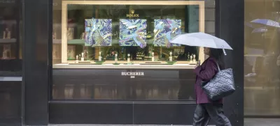 A woman walks by a store selling Rolex watches, on Grendelstrasse, Wednesday, April 16, 2025 in Lucerne, Switzerland. (Urs Flueeler/Keystone via AP)