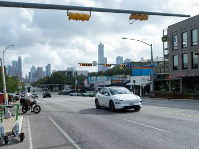 FILE PHOTO: A Tesla robotaxi drives on the street along South Congress Avenue in Austin, Texas, U.S., June 22, 2025. REUTERS/Joel Angel Juarez/File Photo