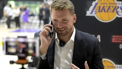 Aug 2, 2025; El Segundo, CA, USA; Los Angeles Lakers Luka Doncic (77) is interviewed by ESPN LA radio following a press conference announcing the signing of a 3-year, 5 million contract extension at UCLA Health Training Center. Mandatory Credit: Jayne Kamin-Oncea-Imagn Images