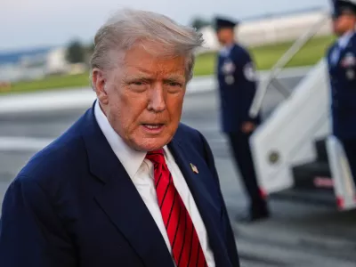 President Donald Trump speaks with reporters before boarding Air Force One at Lehigh Valley International Airport, Sunday, Aug. 3, 2025, in Allentown, Pa. (AP Photo/Julia Demaree Nikhinson)