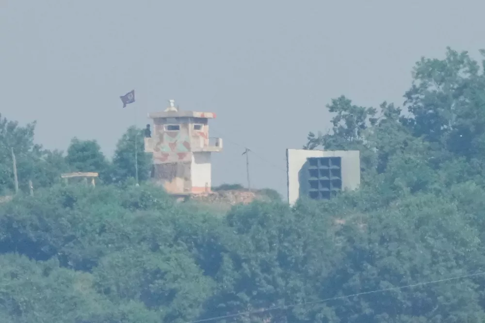 FILE - A North Korean military guard post, left, and loudspeaker are seen from Paju, South Korea, near the border with North Korea, June 12, 2025. (AP Photo/Ahn Young-joon, File)