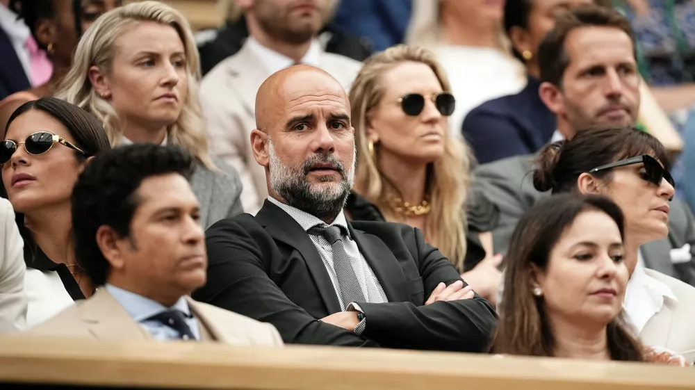 Pep Guardiola seated with his wife Cristina and his daughter Maria in the royal box on day six of the 2024 Wimbledon Championships at the All England Lawn Tennis and Croquet Club, London. Picture date: Saturday July 6, 2024.,Image: 887741026, License: Rights-managed, Restrictions: Editorial use only. No commercial use without prior written consent of the AELTC. Still image use only - no moving images to emulate broadcast. No superimposing or removal of sponsor/ad logos., Model Release: no