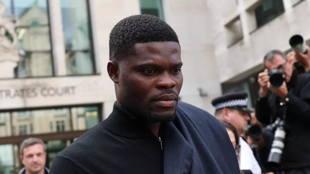 Former Arsenal player Thomas Partey, who has been charged with five counts of rape and one count of sexual assault, walks outside Westminster Magistrates' Court, in London, Britain, August 5, 2025. REUTERS/Hannah McKay