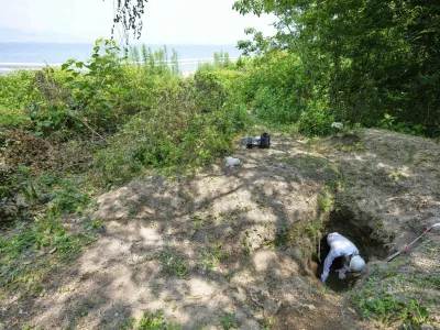 Rebun Kayo, a Hiroshima University researcher, searches for remains of victims of the 1945 Hiroshima bombing in Ninoshima in Hiroshima, western Japan, Tuesday, July 8, 2025. (AP Photo/Eugene Hoshiko)