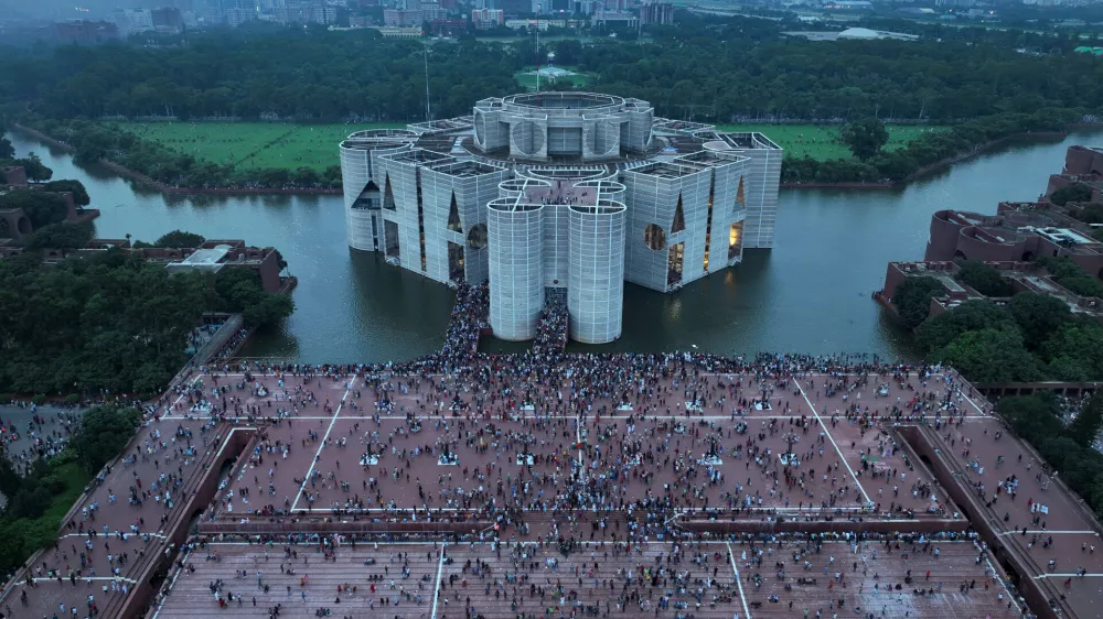 FILE- Protesters celebrate at the Parliament House premise after news of Prime Minister Sheikh Hasina's resignation, in Dhaka, Bangladesh, Aug. 5, 2024. (AP Photo/Fatima Tuj Johora, File)