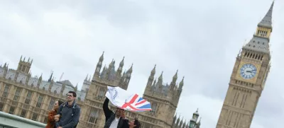 A person struggles to use their umbrella in the wind, as Storm Floris hits parts of Britain, near the Houses of Parliament in London, Britain, August 4, 2025. REUTERS/Toby Melville