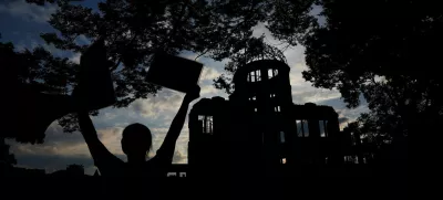 A Pro-Palestinian protester is silhouetted in front of the dome, a day ahead of the 80th anniversary of the World War Two atomic bombing in Hiroshima, western Japan, August 5, 2025. REUTERS/Kim Kyung-Hoon  TPX IMAGES OF THE DAY / Foto: Kim Kyung-hoon