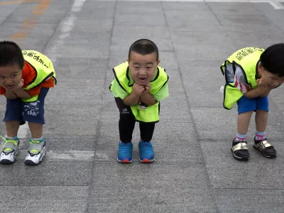 Children practice their postures during a roller blading class outside a park in Beijing, China, Wednesday, June 24, 2015. Roller blading has grown in popularity as instructors and equipment become more easily available in the Chinese capital.  (AP Photo/Ng Han Guan)