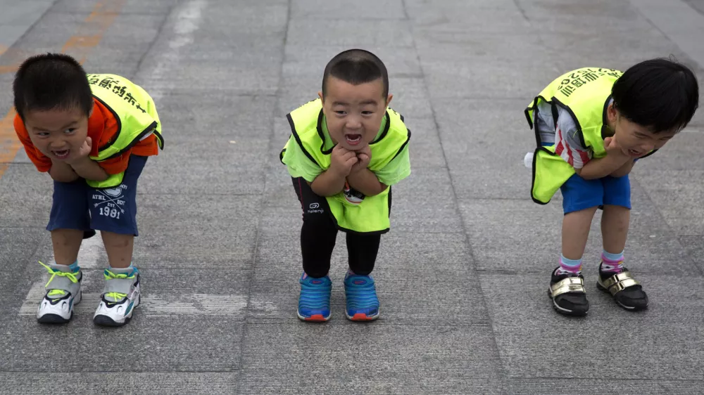 Children practice their postures during a roller blading class outside a park in Beijing, China, Wednesday, June 24, 2015. Roller blading has grown in popularity as instructors and equipment become more easily available in the Chinese capital.  (AP Photo/Ng Han Guan)