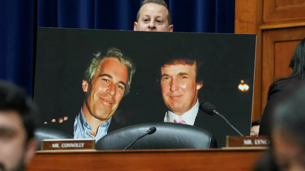 Rep. Jared Moskowitz (D-FL) holds up a photo of former U.S. President Donald Trump with late sex offender Jeffrey Epstein during a meeting of the the House Oversight and Accountability Committee to markup a resolution and report to hold Hunter Biden, President Joe Biden's son, in contempt of Congress, after he refused to appear for a closed-door deposition, at the Capitol in Washington, U.S., January 10, 2024. REUTERS/Kevin Lamarque