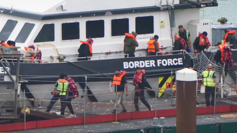 07 August 2025, United Kingdom, Dover: A group of people thought to be migrants are brought in to the Border Force compound in Dover, Kent, from a Border Force vessel following a small boat incident in the Channel. Photo: Gareth Fuller/PA Wire/dpa