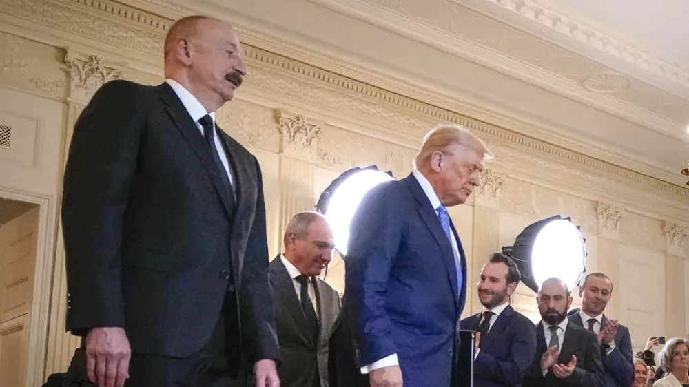Azerbaijan's President Ilham Aliyev, from left, Armenian Prime Minister Nikol Pashinyan and President Donald Trump arrive for a trilateral signing ceremony in the State Dining Room of the White House, Friday, Aug. 8, 2025, in Washington. (AP Photo/Mark Schiefelbein)