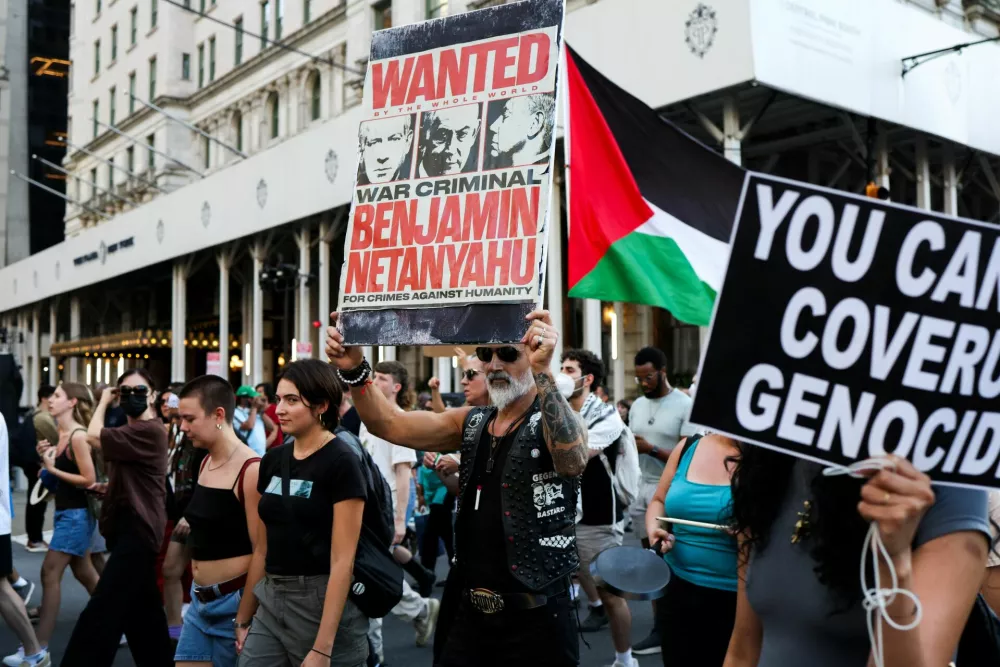Pro-Palestinian protesters, holding a sign with Benjamin Netanyahu, march as they take part in the "Rise Up for Gaza" demonstration in New York City, U.S., August 8, 2025. REUTERS/Adam Gray