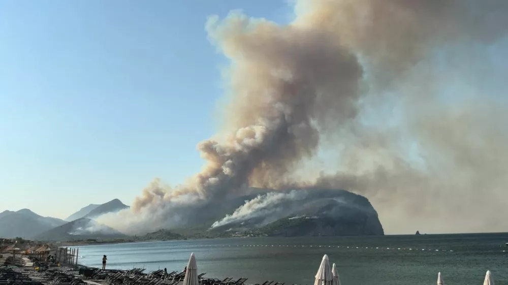 Smoke rises as a wildfire burns in Buljarica, Montenegro, August 12, 2025, in this screen grab obtained from a social media video. Goran Jovanovic/via REUTERS THIS IMAGE HAS BEEN SUPPLIED BY A THIRD PARTY. MANDATORY CREDIT. NO RESALES. NO ARCHIVES. Verification: -Location and date verified by original file metadata from the source.