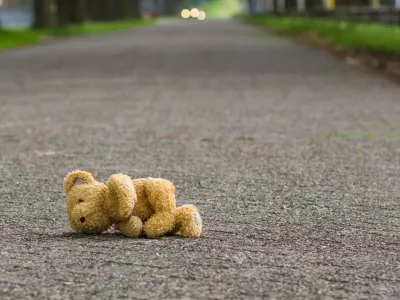 Teddy bear lies on the road