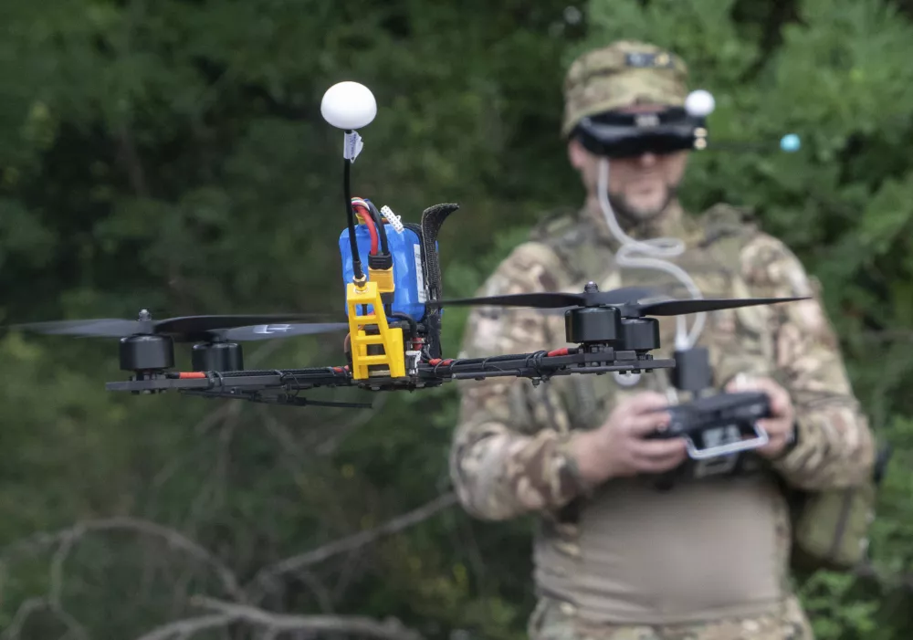 A Ukrainian serviceman of 57th motorised brigade controls an FPV drone at the frontline in Kharkiv region, Ukraine Tuesday, Aug. 12, 2025. (AP Photo/Andrii Marienko)