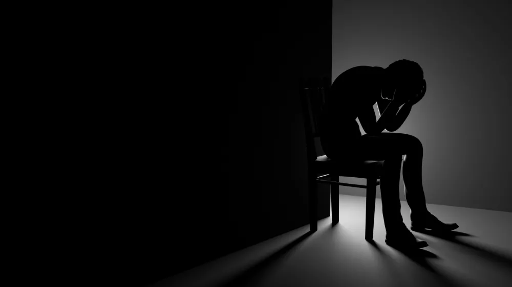 3D Man Sitting on Chair in a Dark Room, Depression or Anxiety Concept Illustration / Foto: Evilwata