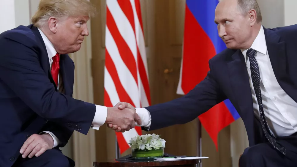 FILE - President Donald Trump, left, and Russian President Vladimir Putin shake hands at the beginning of a meeting at the Presidential Palace in Helsinki, Finland, July 16, 2018. (AP Photo/Pablo Martinez Monsivais, File)