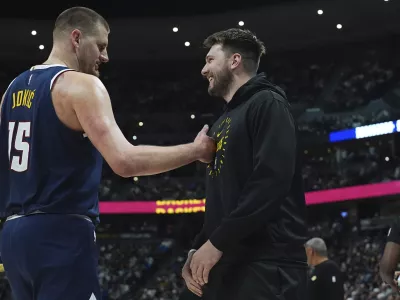 Denver Nuggets center Nikola Jokic, left, greets Los Angeles Lakers guard Luka Doncic, right, in the first half of an NBA basketball game Friday, March 14, 2025, in Denver. (AP Photo/David Zalubowski)