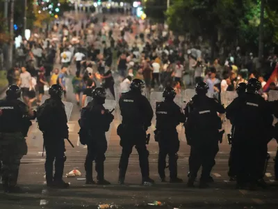 Serbian gendarmerie officers guard the street during an anti-government protest near Serbian Progressive Party office in Belgrade, Serbia, Thursday, Aug. 14, 2025. (AP Photo/Darko Vojinovic)