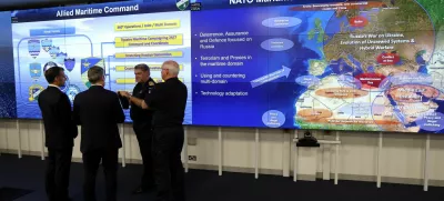 France's President Emmanuel Macron and Britain's Prime Minister Keir Starmer listen to a NATO military officer during a Coalition of the Willing meeting at a military base at Northwood Headquarters in north-west London, Britain, on July 10, 2025. LUDOVIC MARIN/Pool via REUTERS