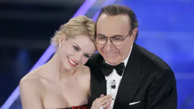 Italian TV celebrity Pippo Baudo with Hungarian actress Andrea Osvart during the "Festival di Sanremo" Italian song contest, in San Remo, Italy, Monday, Feb. 25, 2008. (AP Photo/Antonio Calanni)