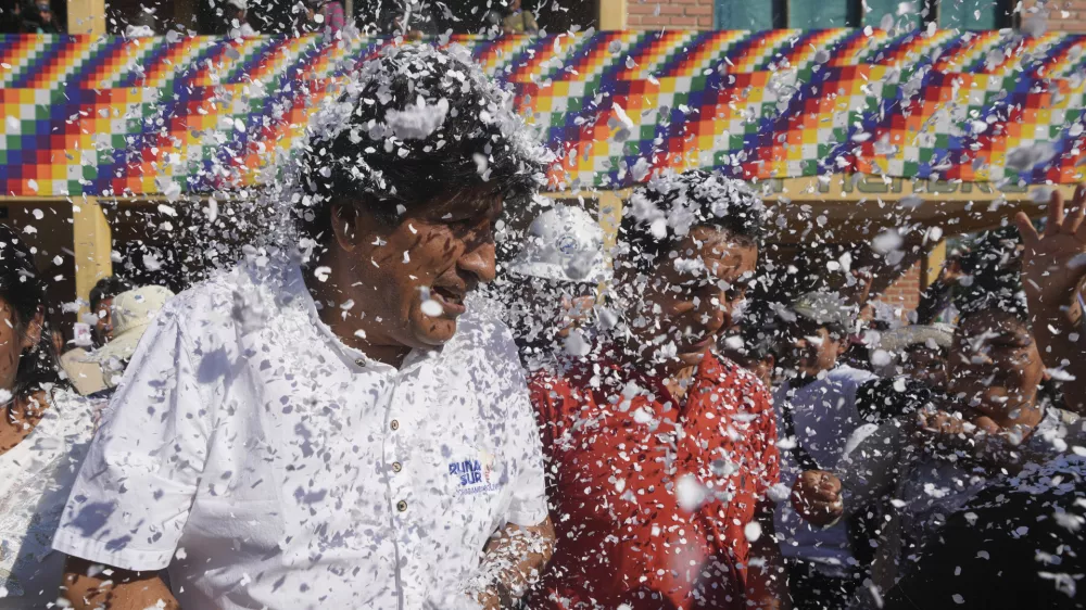 Supporters throw confetti on former President Evo Morales after a meeting with a peasants' federation, before he voted in presidential and legislative elections in Villa 14 de Septiembre, in the Chapare region of Bolivia, Sunday, Aug. 17, 2025. (AP Photo/Jorge Saenz)
