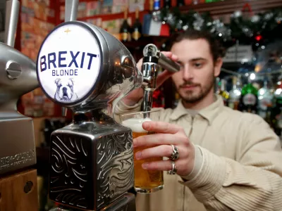 FILE PHOTO: Thibault, barman at the Cricketer English Pub, serves a Brexit draft beer in Paris, France, December 17, 2018. REUTERS/Charles Platiau/File Photo