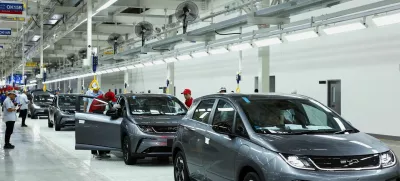 FILE PHOTO: Workers check the EV cars inside BYD's first electric vehicle (EV) factory in Southeast Asia, a fast-growing regional EV market where it has become the dominant player, in Rayong, Thailand, July 4, 2024. REUTERS/Chalinee Thirasupa/File Photo