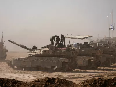 Israeli soldiers stand on a tank as seen from the Israeli side of the Israel-Gaza border, Israel August 18, 2025. REUTERS/Amir Cohen