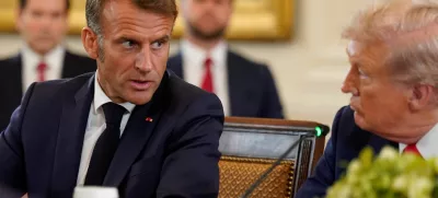 French President Emmanuel Macron speaks to U.S. President Donald Trump during a meeting with Ukrainian President Volodymyr Zelenskiy (not pictured) and European leaders amid negotiations to end the Russian war in Ukraine, at the White House in Washington, D.C., U.S., August 18, 2025. REUTERS/Al Drago