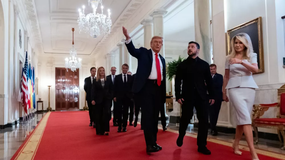 President Donald Trump, center, walks in the Cross Hall with Ukrainian President Volodymyr Zelenskyy, followed by British Prime Minister Keir Starmer, French President Emmanuel Macron, German Chancellor Friedrich Merz, Italian Prime Minister Giorgia Meloni, Finnish President Alexander Stubb, NATO Secretary General Mark Rutte and European Commission President Ursula von der Leyen, at the White House, Monday, Aug. 18, 2025, in Washington. (AP Photo/Alex Brandon) / Foto: Alex Brandon