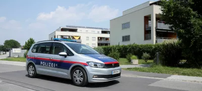 Police officers sit in a car near the flat of the suspect, in a deadly shooting at a secondary school in Graz, in Kalsdorf, Austria, June 11, 2025. REUTERS/Leonhard Foeger