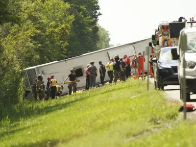 First responders work to rescue victims at the scene of a tour bus that crashed and rolled over on the New York State Thruway near Pembroke, N.Y., Friday, Aug. 22, 2025. (Libby March/Buffalo News via AP)