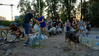 Local residents wait in line to collect water delivered by a tank truck in the course of Russia-Ukraine military conflict, in Donetsk, a Russian-controlled city of Ukraine, August 21, 2025. REUTERS/Alexander Ermochenko