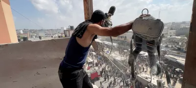 A man reacts as he holds the equipment used by Palestinian cameraman Hussam al-Masri, who was a contractor for Reuters, at the site where he was killed along with other journalists and people in Israeli strikes on Nasser hospital, in Khan Younis in the southern Gaza Strip, in this still image taken from a video shot by Reuters contractor Hatem Khaled, who was wounded shortly afterwards in another strike while he was filming the site, August 25, 2025. REUTERS/Hatem Khaled   TPX IMAGES OF THE DAY