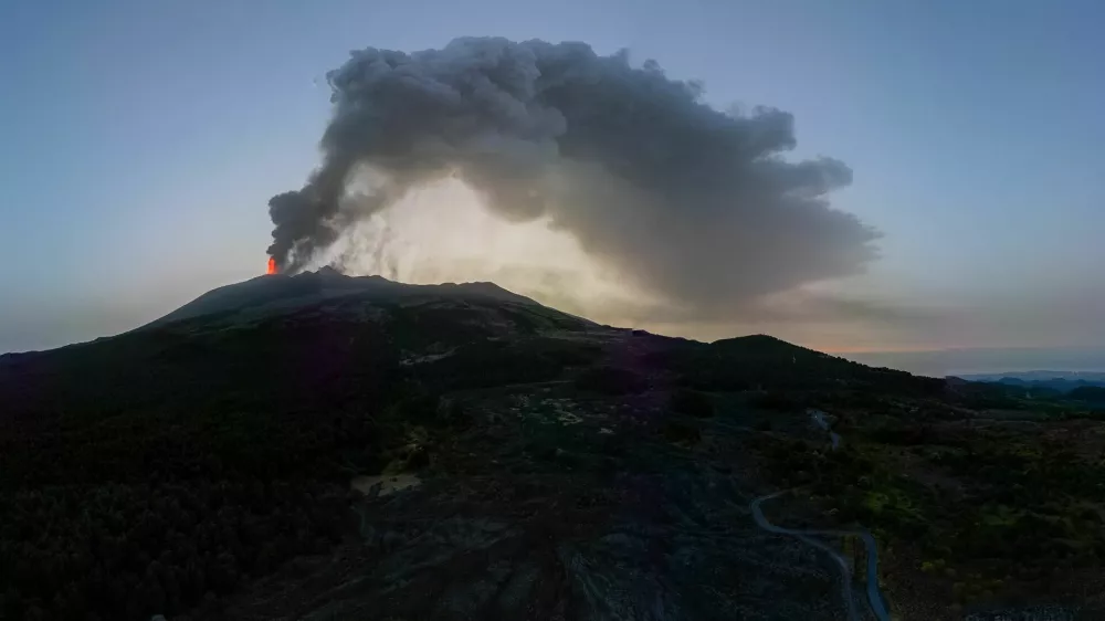 A drone view shows smoke rising from a crater of Mount Etna at dawn, Europe's most active volcano, Italy July 7, 2024. REUTERS/Etna Walk/Giuseppe Di Stefano