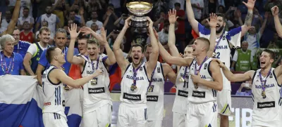 Slovenia's Goran Dragic, center, lifts the trophy after defeating Serbia in the Eurobasket European Basketball Championship final match in Istanbul, Sunday, Sept. 17. 2017. (AP Photo/Thanassis Stavrakis)
