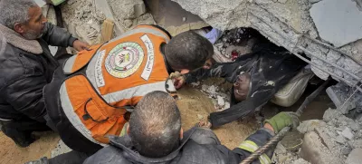 FILE - EDS NOTE: GRAPHIC CONTENT - Rescue workers and volunteers attempt to pull the body of a man from the rubble following an Israeli army airstrike in Khan Younis, southern Gaza Strip, Thursday, March 20, 2025. (AP Photo/Mariam Dagga, File)