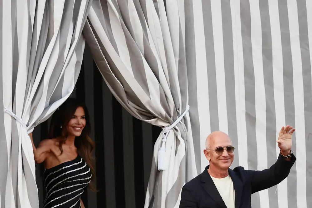 Amazon founder Jeff Bezos and Lauren Sanchez leave the Aman Venice hotel, ahead of their expected wedding, in Venice, Italy, June 25, 2025. REUTERS/Yara Nardi